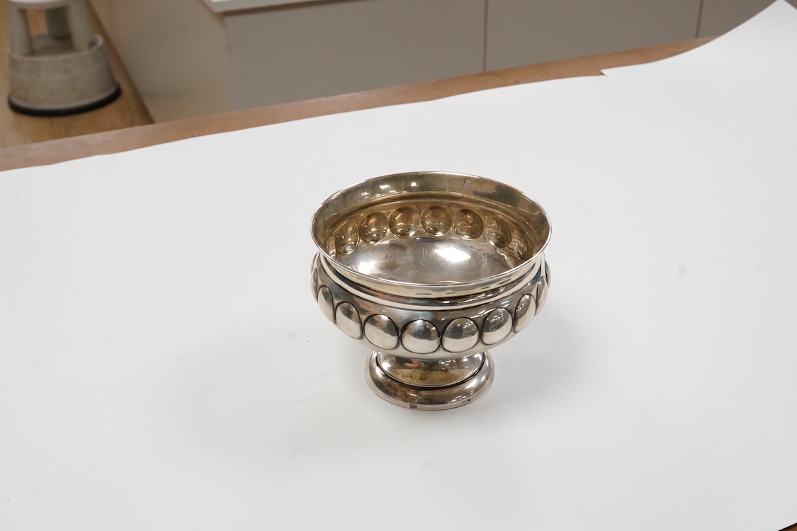 A George V silver pedestal bowl, with dimpled body, Maxfield & Sons Ltd, London, 1912, diameter 11.5cm, weighted, gross 6.1oz.